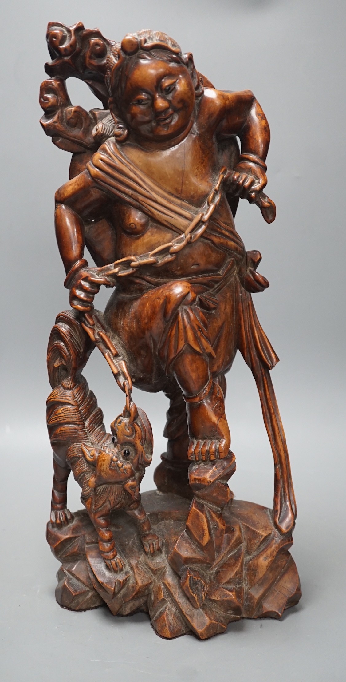 A large Chinese hardwood figure of Liu Hai, early 20th century, 47cm